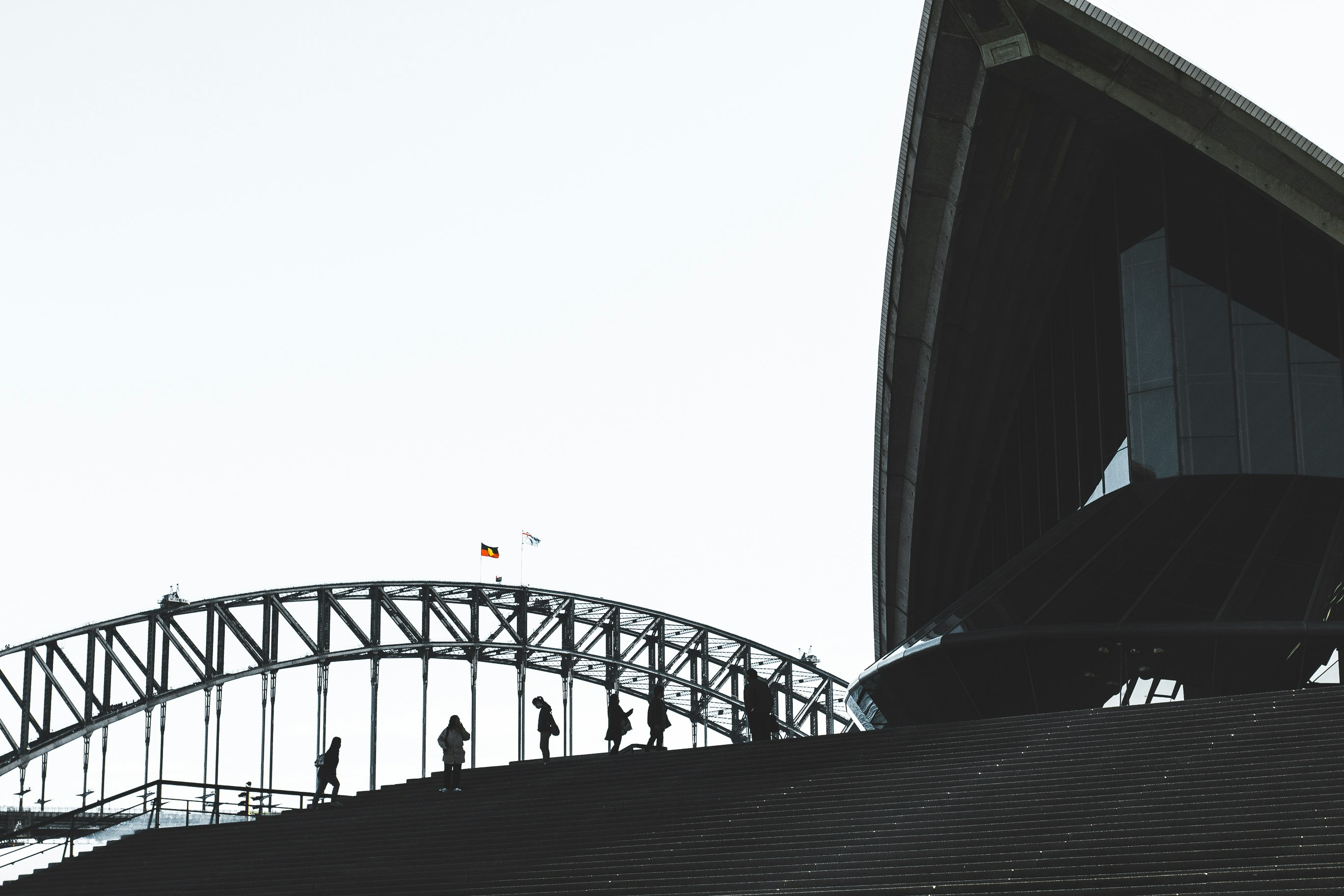 low angel photography of people standing near bridge